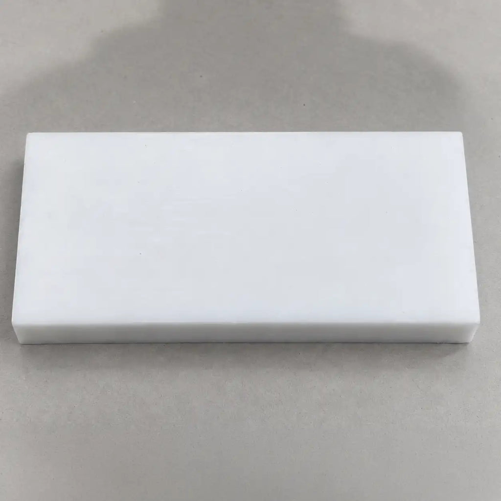 Custom-sized Teflon (PTFE) block by BouwmarktXL, showing a smooth, white, solid PTFE sheet with clean edges and uniform surface.