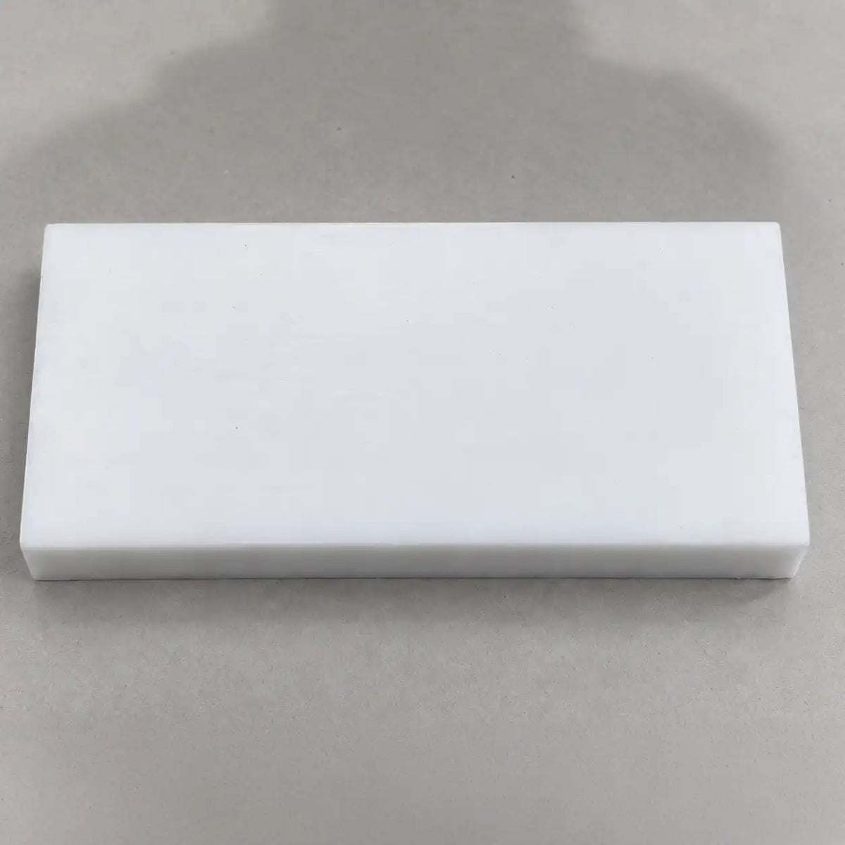 Custom-sized Teflon (PTFE) block by BouwmarktXL, showing a smooth, white, solid PTFE sheet with clean edges and uniform surface.