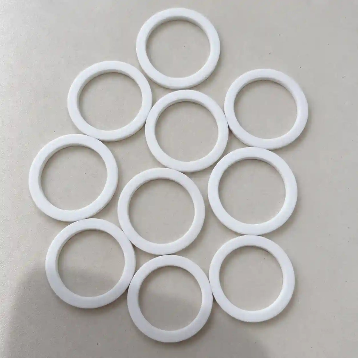 Small Teflon rings made of durable plastic, custom-sized for various construction and industrial applications.