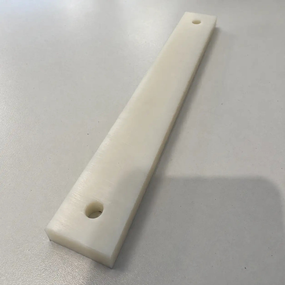 Colorful plastic building blocks from BouwmarktXL, arranged in a playful pattern on a white background.