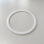 Close-up of a small custom-made plastic PTFE ring with narrow width, designed for precise fitting and durability.