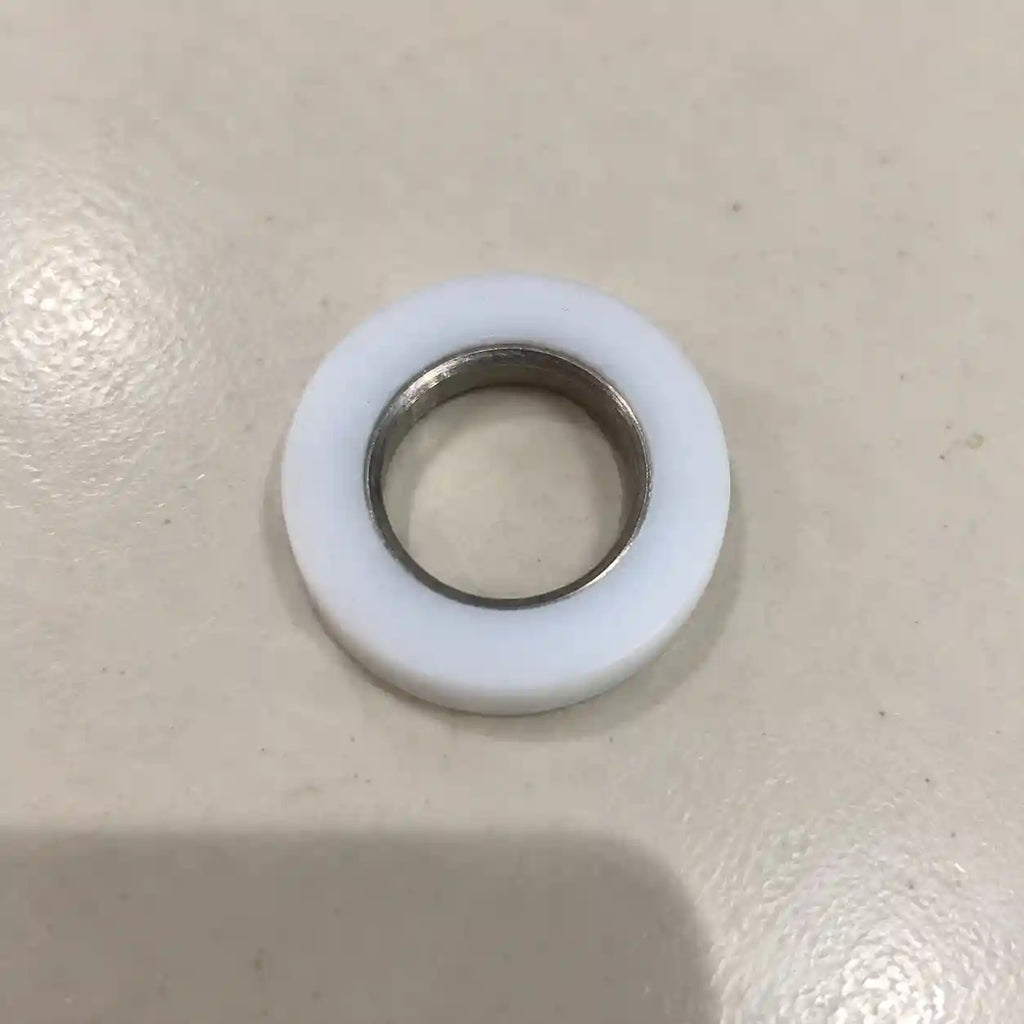 Teflon (PTFE) custom ring with metal inner sleeve, used for sealing or insulating in industrial applications.