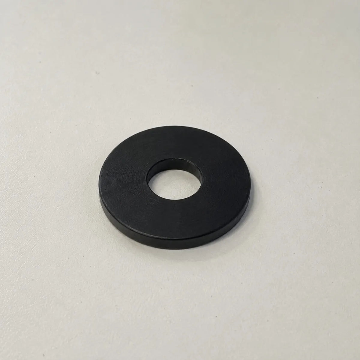 Black custom-made plastic ring from BouwmarktXL, featuring realistic PTFE material for industrial or DIY applications.